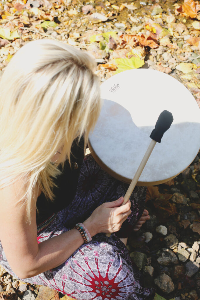 A spiritual counselor beats a shamanic drum and guides people on their self-discovery journey 